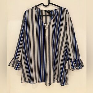 Black white and blue vertical striped top with quarter zipper